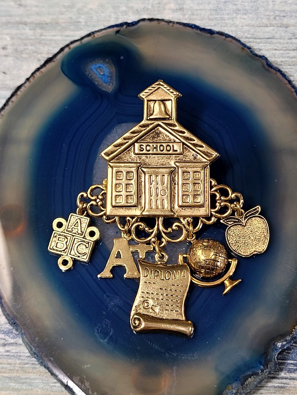 Gold Schoolhouse Brooch with Apple, Diploma, A+ Globe and ABC blocks Charms.